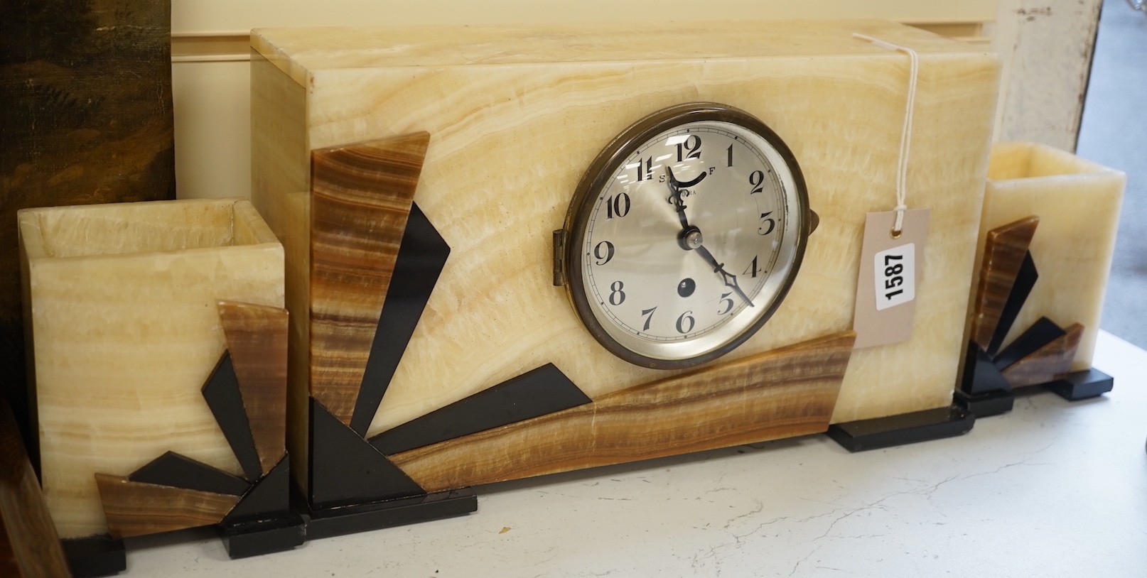 An Art Deco onyx clock garniture